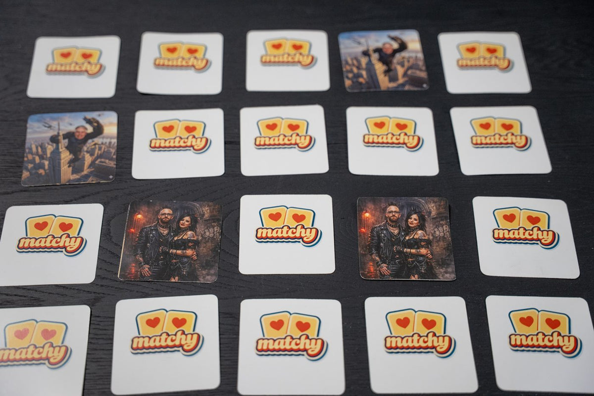 A Matchy Matchy game on the table with many family cards turned face up among logo backs